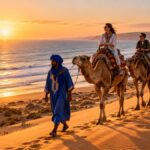 Camel caravan on the dunes near Agadir at sunset