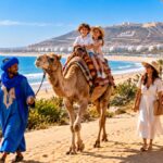 Family with children on a camel ride in Agadir